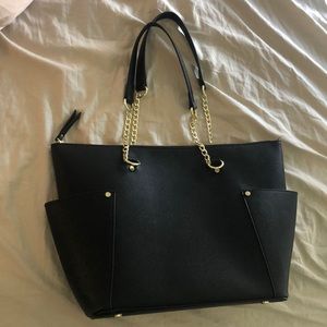 black mid size purse with gold zipper
